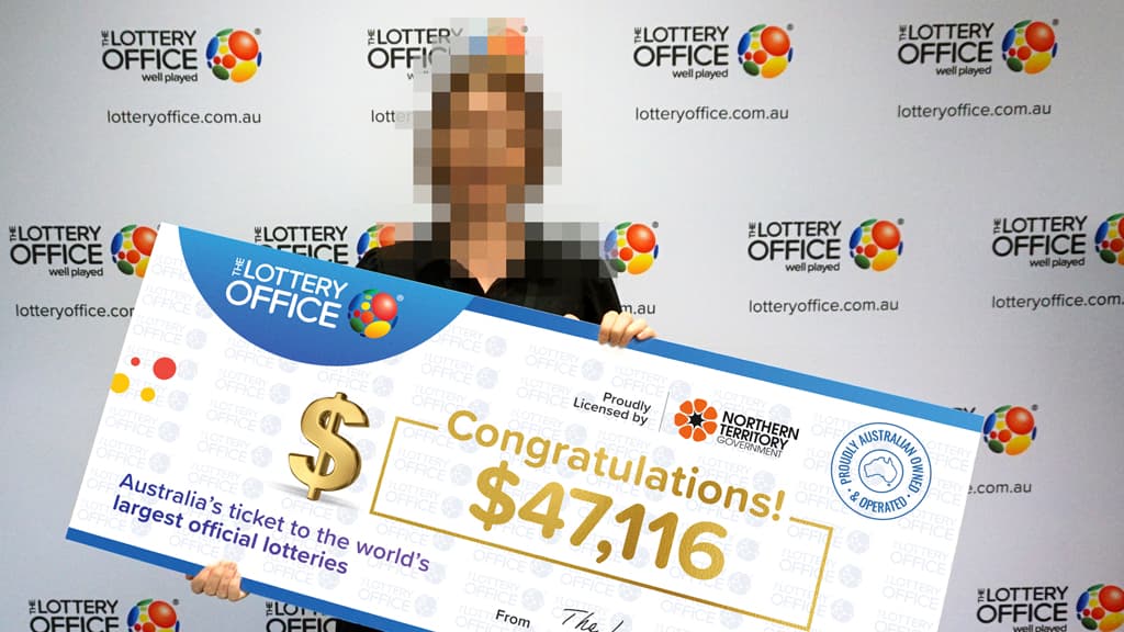 Young woman holding a cheque.