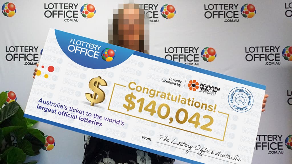 Mature woman holding a cheque.