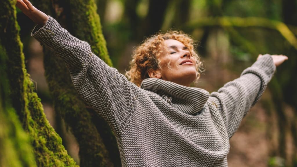 Overjoyed happy woman enjoying the green beautiful nature