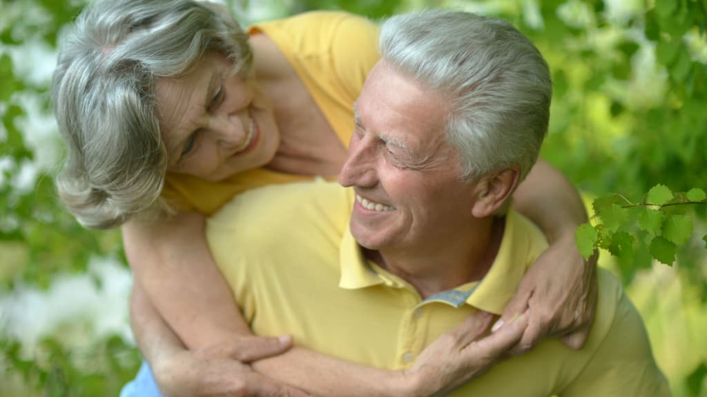 Mature couple hugging.