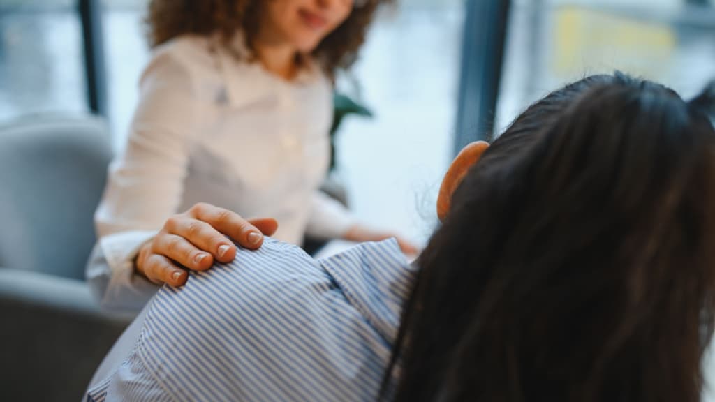 Woman being comforted.