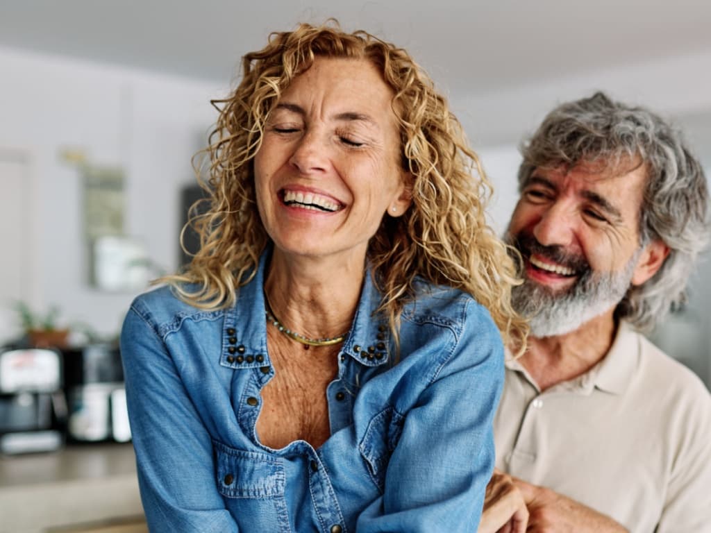 Mature man and woman laughing