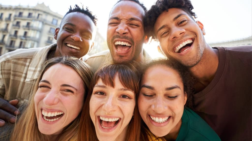 Close up of Five cheerful faces of young friends taking selfie portrait.