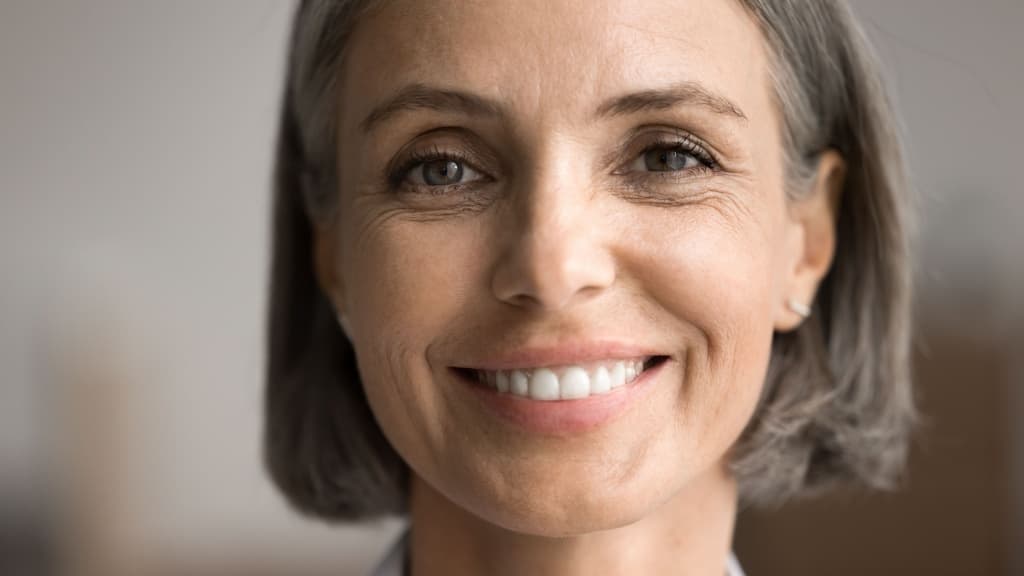 Portrait of happy beautiful middle-aged 50s woman with short haircut